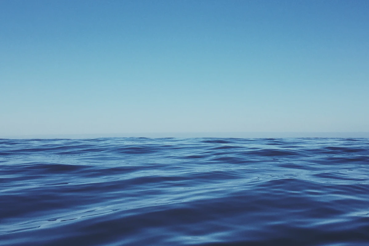 Rippled open water fading toward a clear horizon